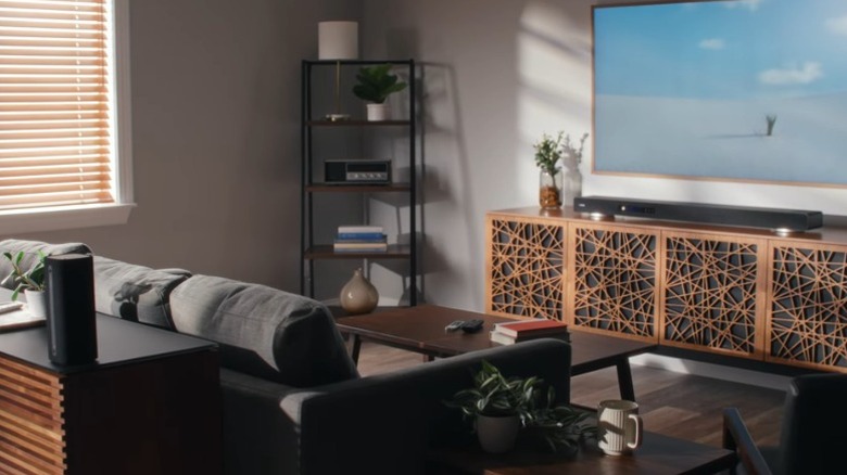 Yamaha True X Surround 90A soundbar and rear speaker in a room full of wood furniture