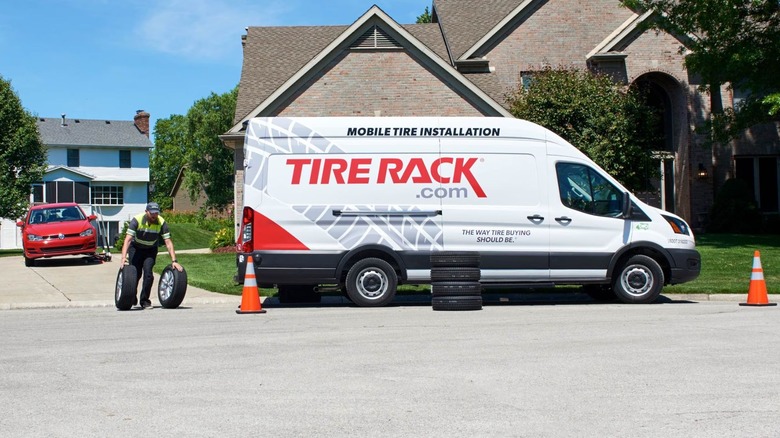 tire rack installer van outside a home
