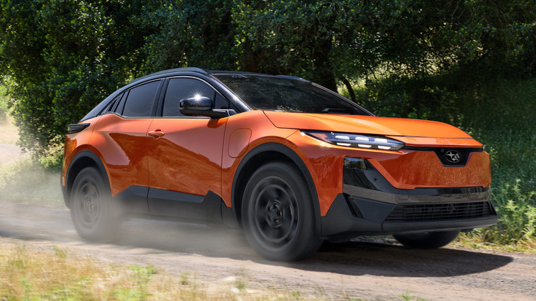 Front 3/4 view of 2026 Subaru Uncharted on dusty forest trail