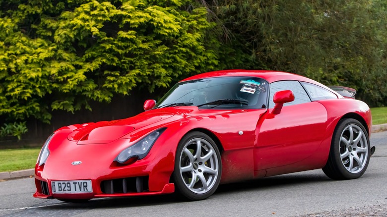 Red 2005 TVR Sagaris in front of greenery