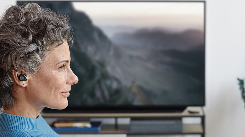 woman wearing Sennheiser TV Clear Set 2 earbuds