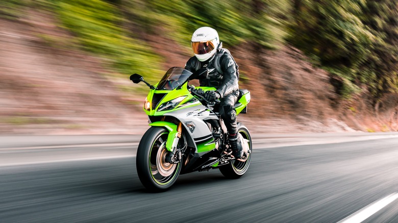 person riding kawasaki bike