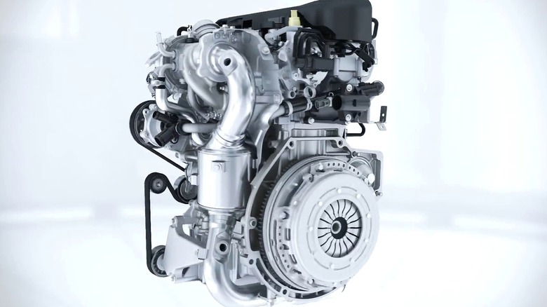 A fully exposed Ford 1.0-liter EcoBoost engine rendered against a clean white background, while showing off its turbocharger, accessory belt layout, and clutch assembly in full detail.