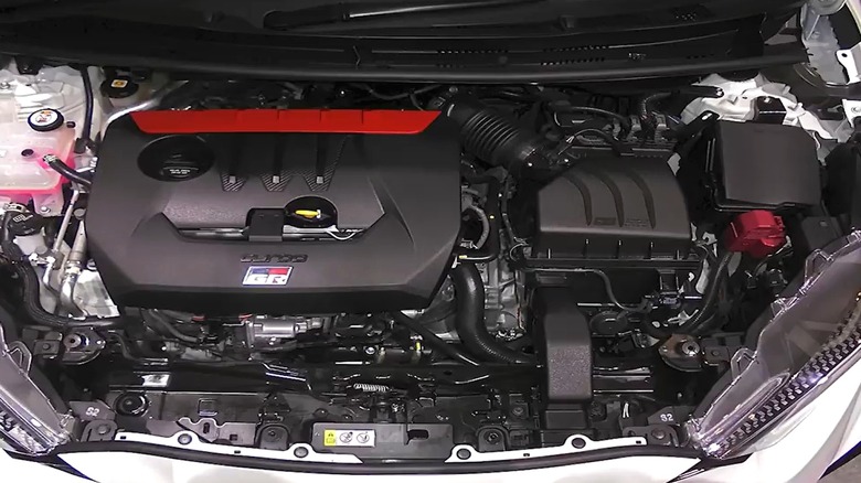 The Toyota G16E-GTS engine dressed in its signature red engine cover, sitting proudly under the hood of what clearly looks like a performance-built hot hatch.