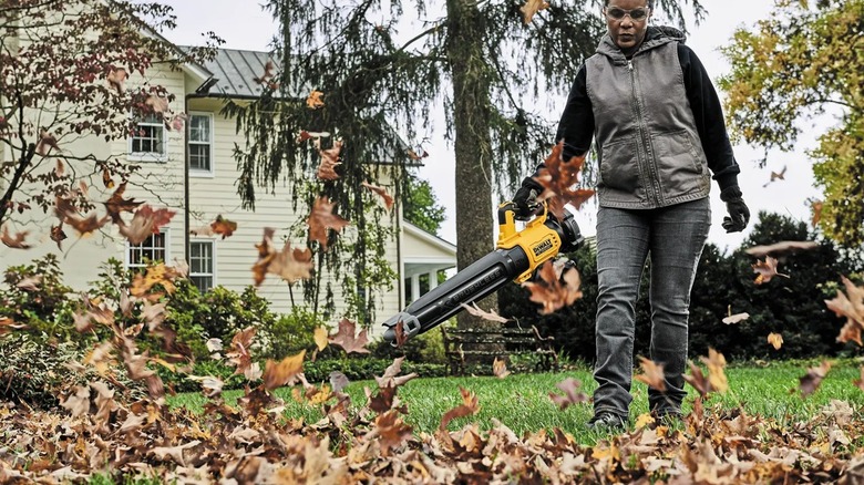 Person using powered DeWalt blower