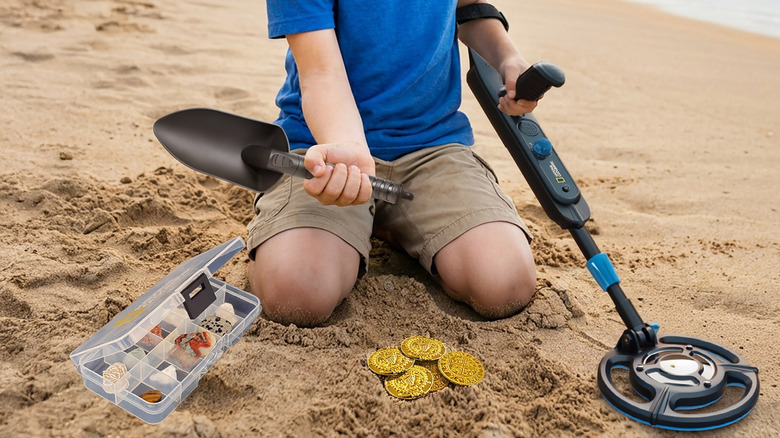 Kid using junior metal detector