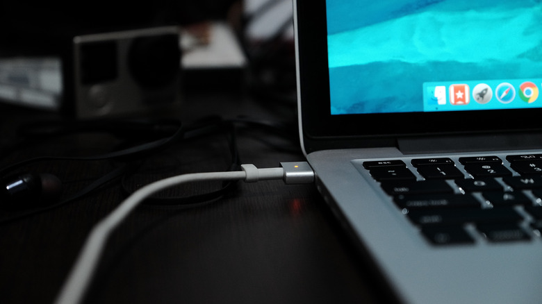 MacBook charging on a desk