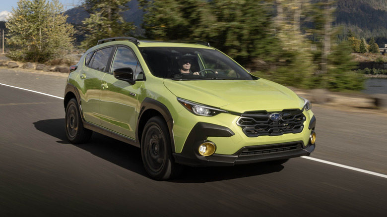 A light green 2026 Subaru Crosstrek Hybrid on the road