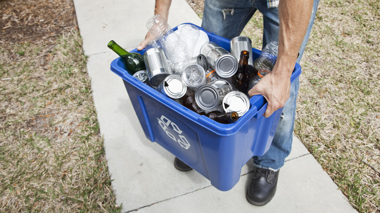 Man carrying recycling bin