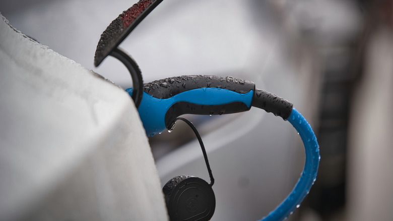 Rain-splashed EV charger plug