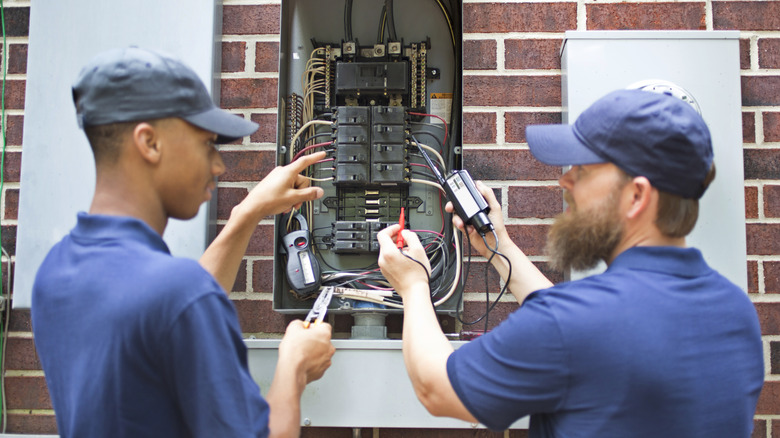 Electricians upgrading breaker box