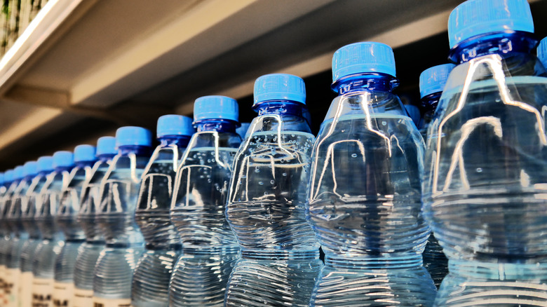 A line of plastic bottles at a supermarket.