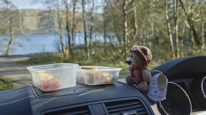 Boxes of snacks resting on a dashboard.