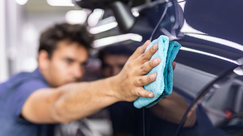 man cleaning car