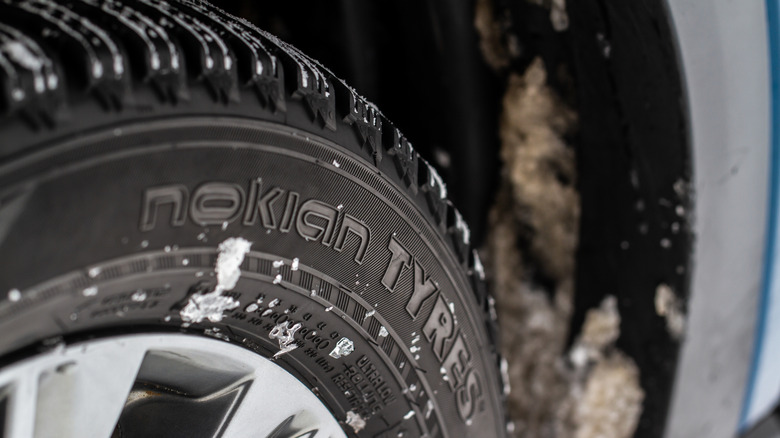 Nokian Tyres photographed close-up with dirt, snow, and ice