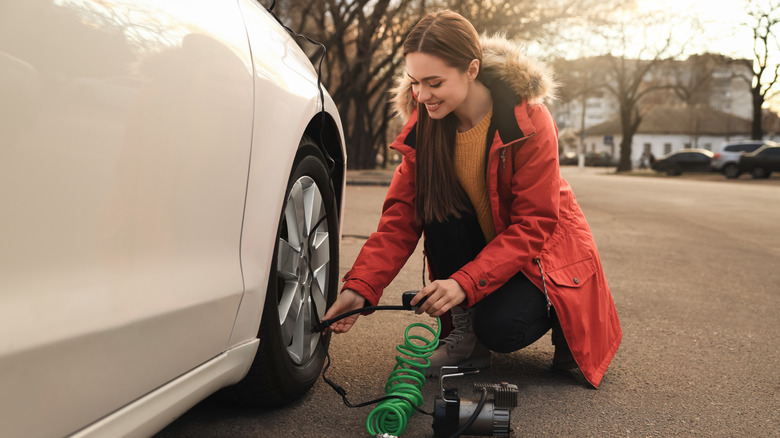 Woman inflating her tires during the day
