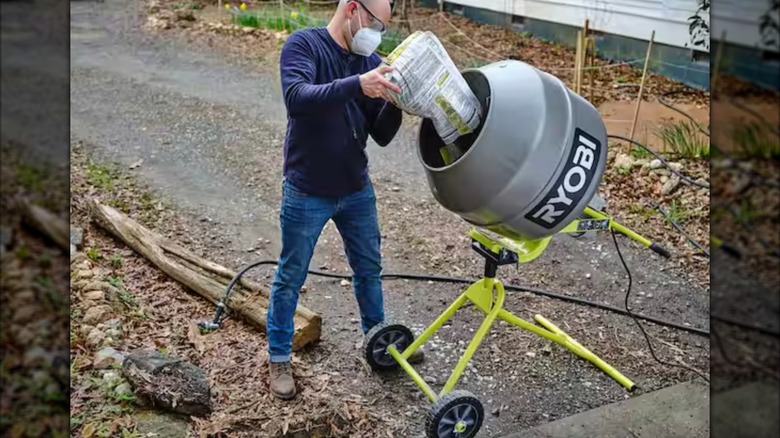 Person pouring cement mix into Ryobi Portable Cement Mixer