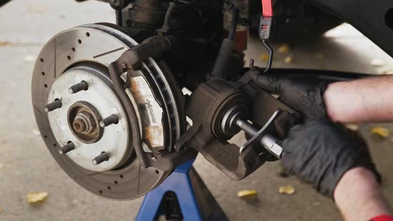 using a pad retractor on a brake caliper