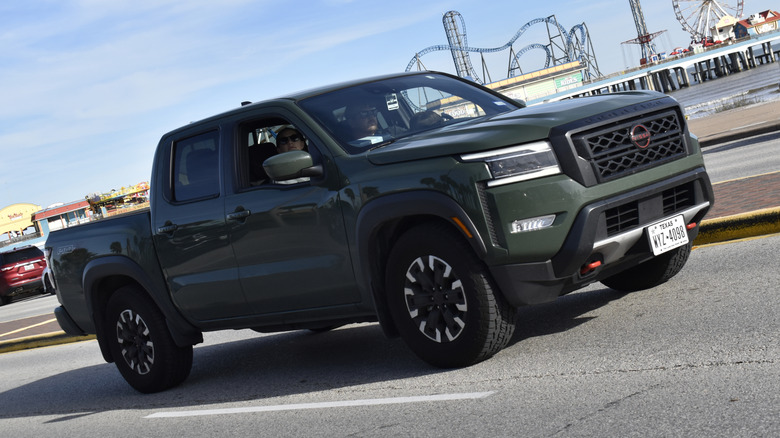 Nissan Frontier green truck in traffic