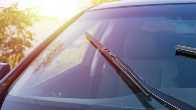 Windshield wipers going across windshield glass