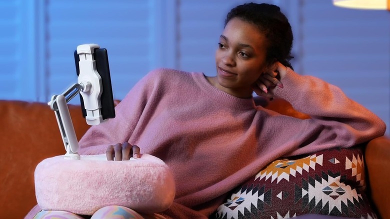 woman reading on tablet with pillow stand