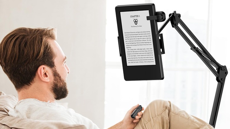 man reading Kindle with remote