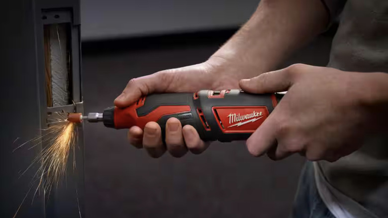 Milwaukee M12 Rotary Tool in use, creating sparks