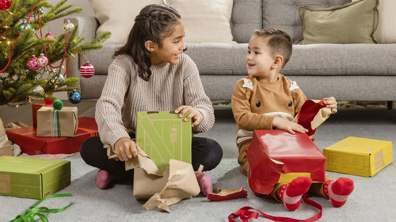Kids unwrapping Kiwico gift boxes