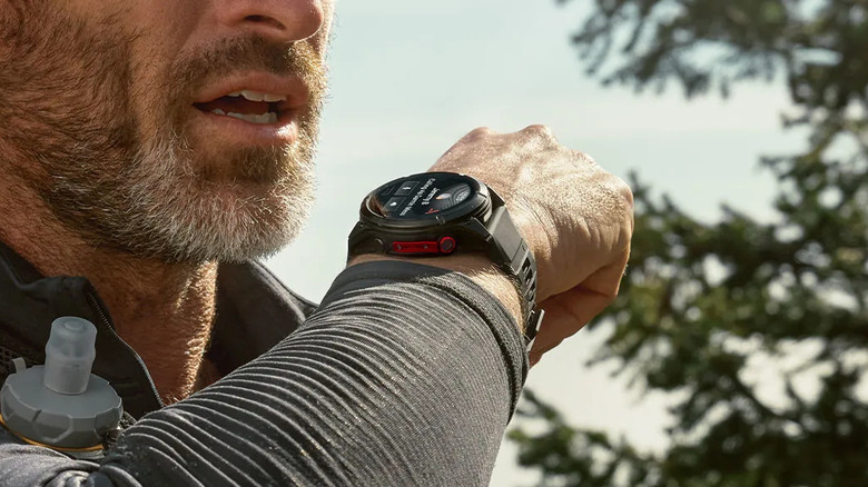 A person speaking into the Garmin Fenix 8 Pro smartwatch