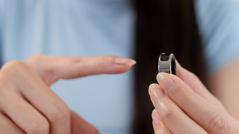 A person about to wear a smart ring