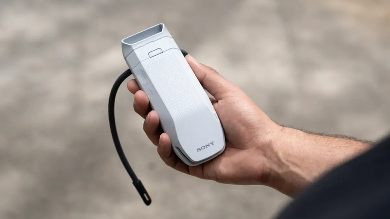 A person holding the Sony Reon Pocket Pro Plus