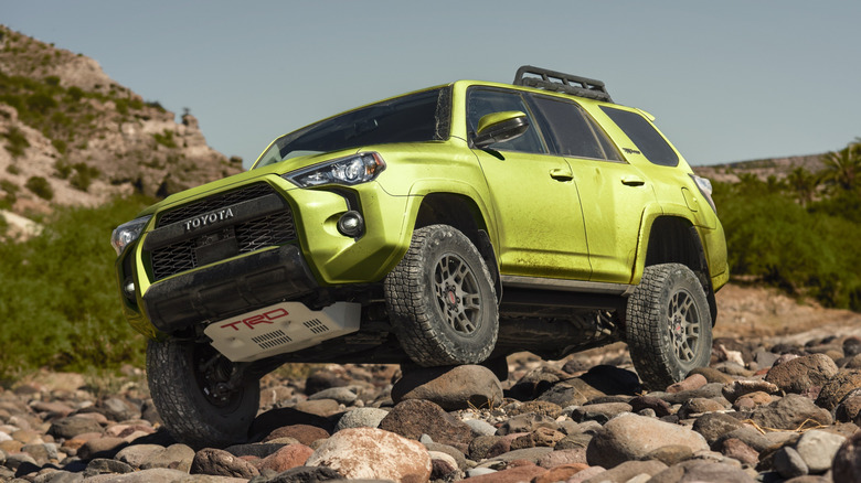 Front 3/4 view of lime colored Toyota 4Runner TRD Pro parked on rocks.
