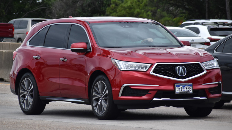 red Acura MDX on road