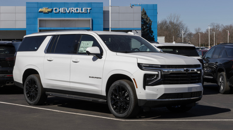 A white Chevrolet Suburban at a dealership