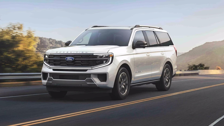 A white Ford Expedition driving