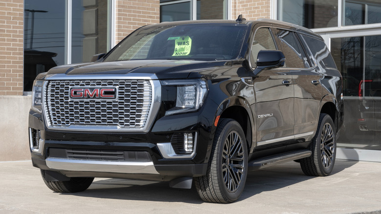 A black GMC Yukon at a dealership