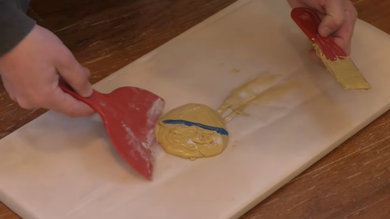 Person mixing Bondo wood filler