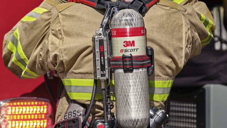 Firefighter wearing a back harness with 3M Scott equipment