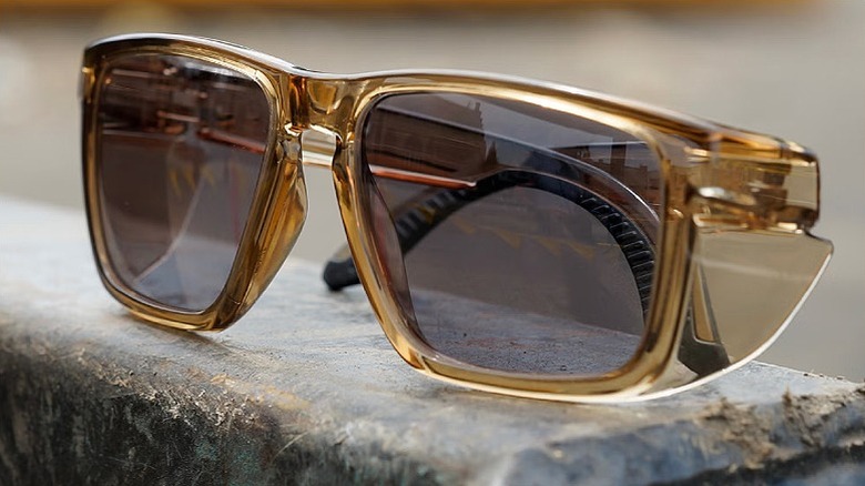 Protective sunglasses placed on a stone.