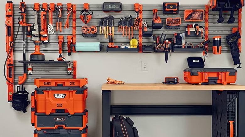 Several Klein Tools products hung on the wall board and placed on the table.