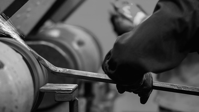 Using a hand tool at a metalworking site.