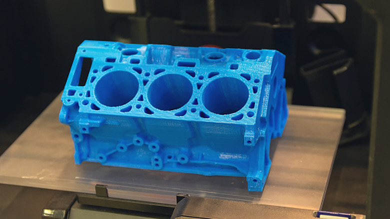 3D printed engine block model sitting on a 3D printer