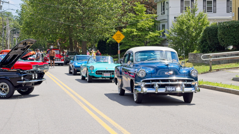 Classic cars on the road still going strong during a car show meetup