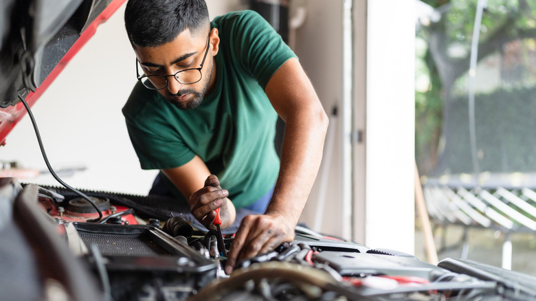 home mechanic working on a car
