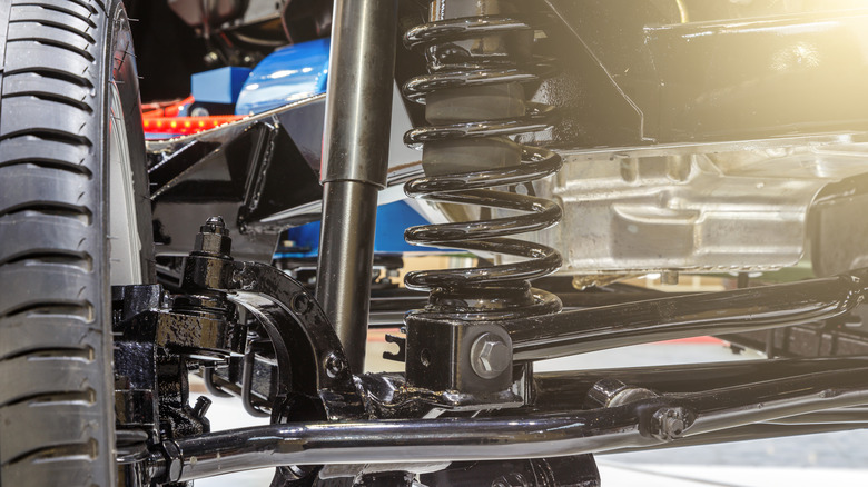 A close up of a suspension element on a car wheel