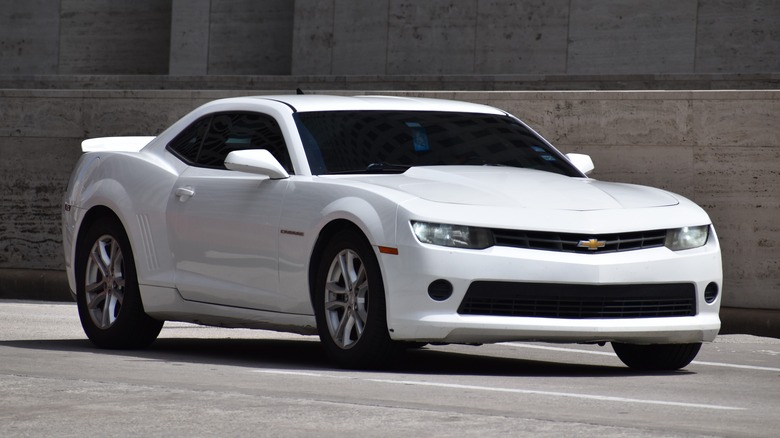 A white Chevy Camaro on a street