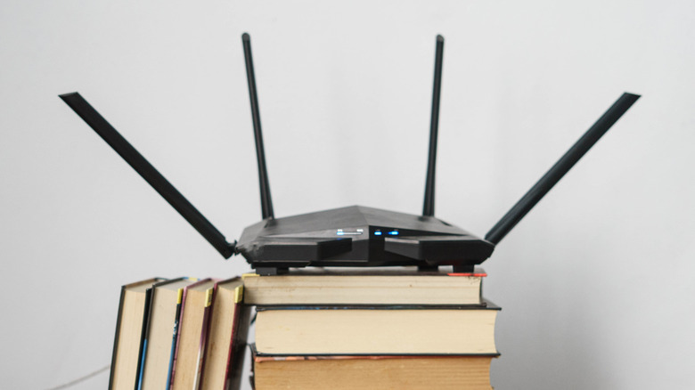 Wi-Fi router sitting on a stack of books