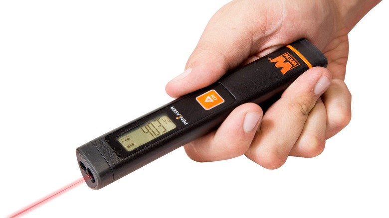 Person using WEN laser distance measurer