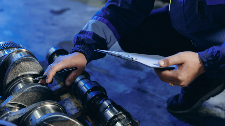 Technician examines diesel engine components