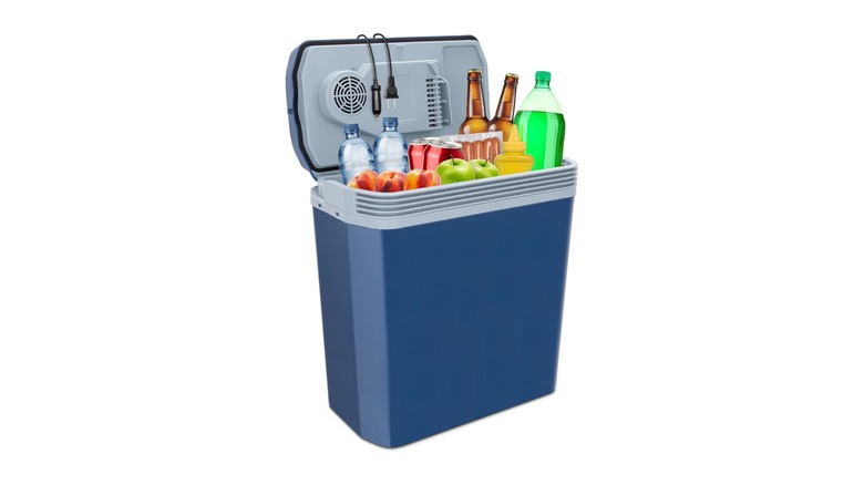 Tall blue cooler displaying bottles of drinks and fruits